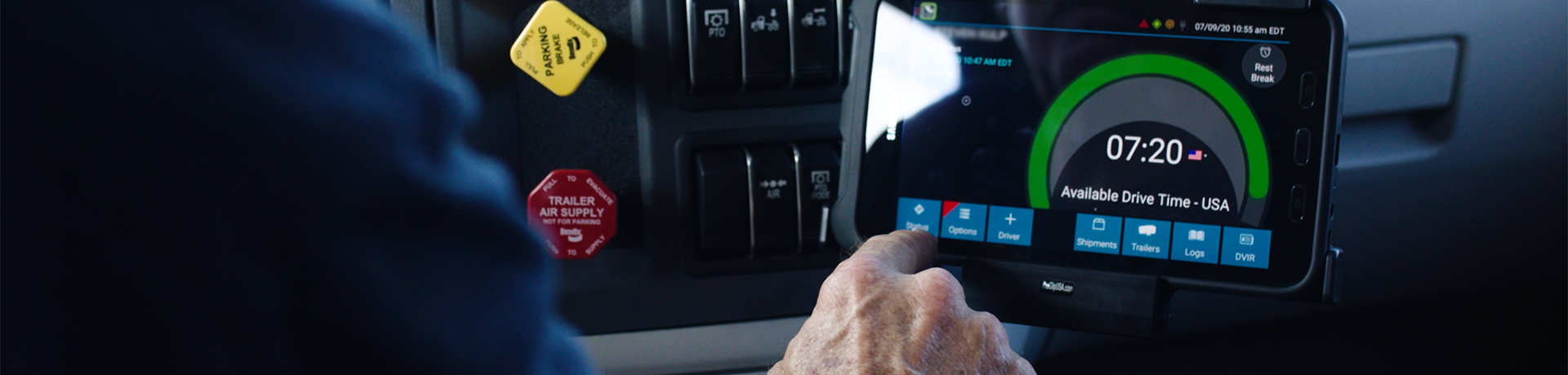 Man in truck with pushing a button on the portable tablet