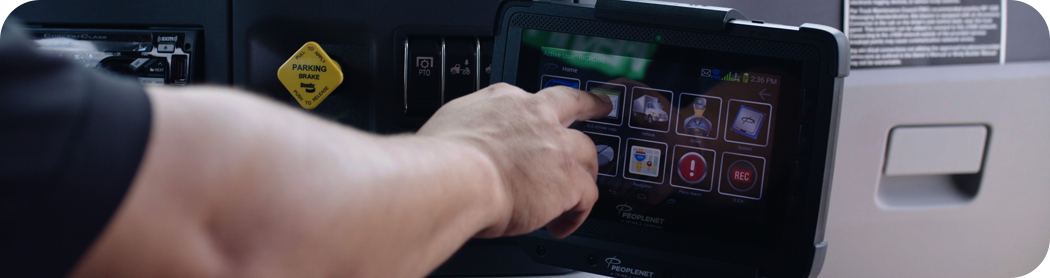 Person pushing the tablet button inside the truck